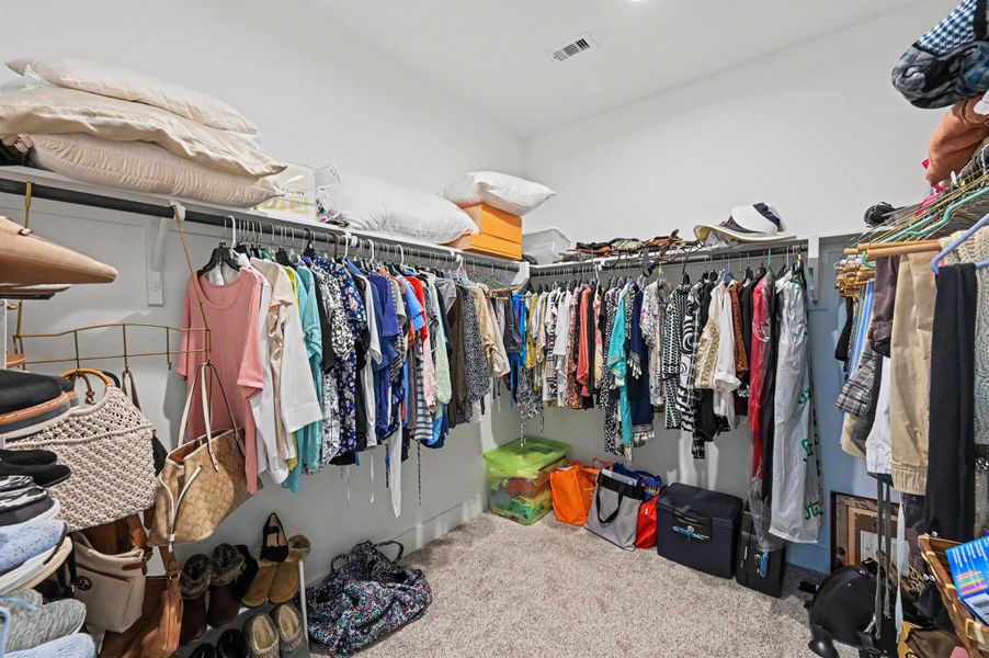 Primary bedroom walk-in-closet. Primary bedroom walk-in-closet.