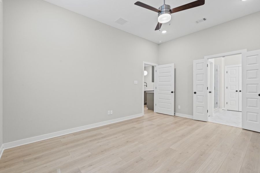 Unfurnished bedroom with light wood-style floors, a ceiling fan, and recessed lighting