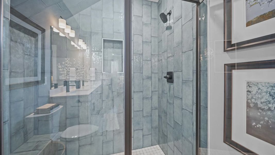 Highly functional and elegant en-suite with dual vanities, tiled walk-in shower, and refined finishes