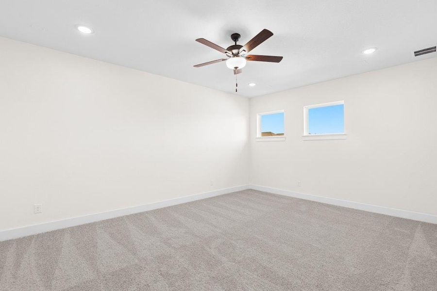 Spare room featuring light carpet, recessed lighting, and a ceiling fan Spare room featuring light carpet, recessed lighting, and a ceiling fan