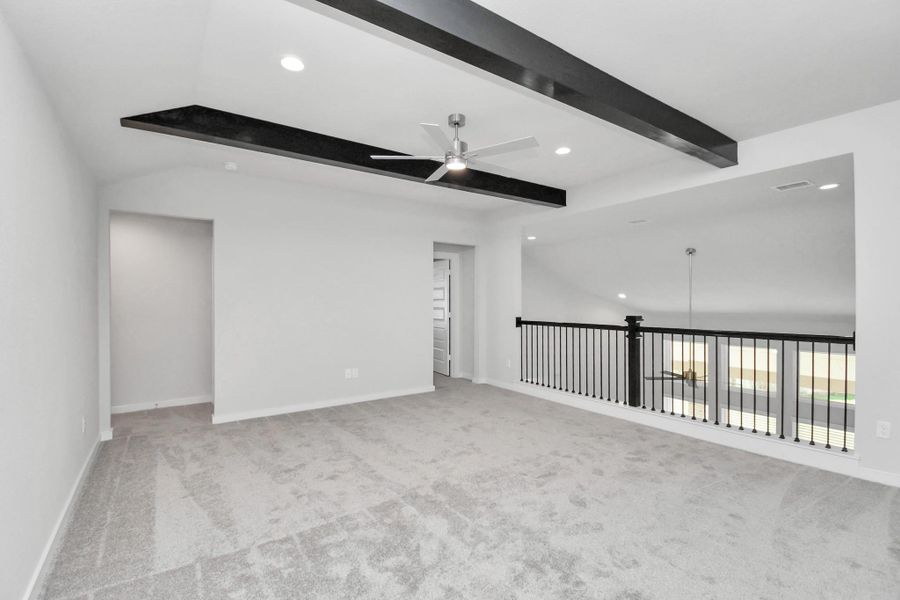 Discover a haven of leisure in this fantastic game room! Whether you're seeking a casual hangout or an adult gaming retreat, this space has it all. Enjoy the luxurious feel of plush carpet underfoot, the expansive ambiance of high ceilings, custom paint that adds a touch of personality, and windows that flood the room with refreshing natural light. Sample photo of completed home with similar floor plan. Actual colors and selections may vary.