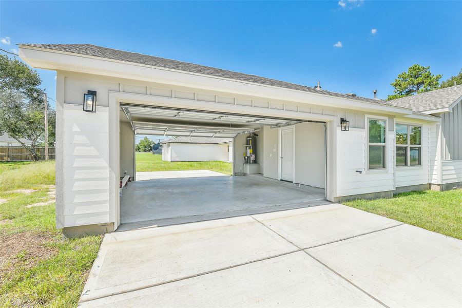 Attached two-car garage with additional driveway space and private entry into the home, offering convenience and ample storage options.