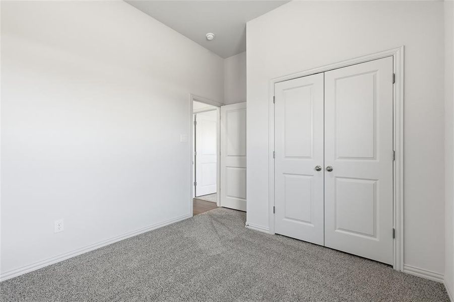 Unfurnished bedroom with carpet floors and a closet