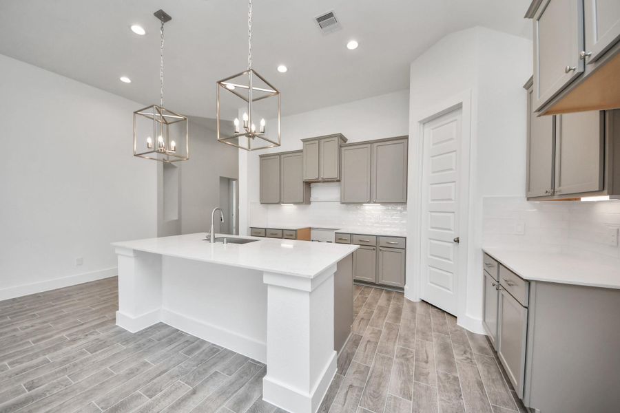 The open concept effortlessly connects the kitchen to the expansive family room, forming a perfect hub for gatherings. This seamless flow creates an inviting space where cooking and socializing come together harmoniously.
