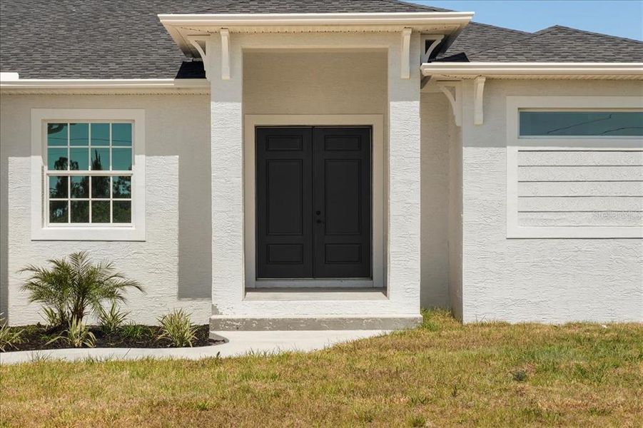 Front exterior of a new home in , Port Charlotte, FL, highlighting curb appeal (Image 1).