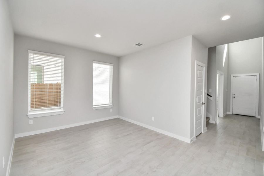 Make memories gathered around the table with your family and friends! This spacious dining room features elegant flooring, custom paint, and adjacent to family room and kitchen for open concept feel. Sample photo of completed home with similar floor plan. Actual colors and selections may vary.