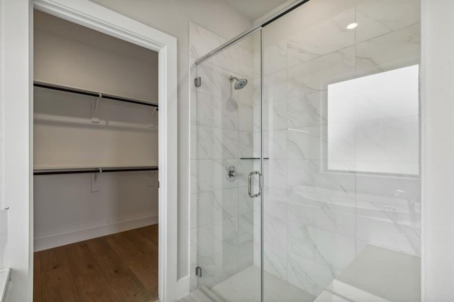 Bathroom featuring an enclosed shower and hardwood / wood-style flooring