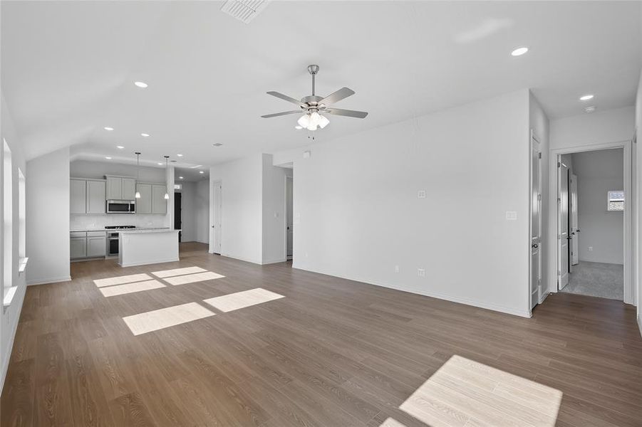 Unfurnished living room featuring recessed lighting, light wood finished floors, and a ceiling fan Unfurnished living room featuring recessed lighting, light wood finished floors, and a ceiling fan