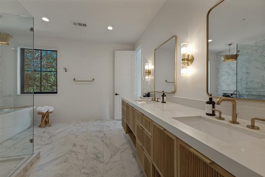 Spacious bathroom with marble-finish floor tiling and a large window Spacious bathroom with marble-finish floor tiling and a large window