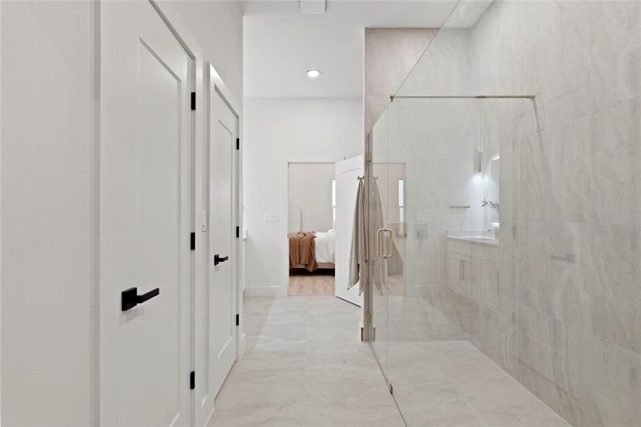 Full bath with a shower stall, connected bathroom, and recessed lighting Full bath with a shower stall, connected bathroom, and recessed lighting