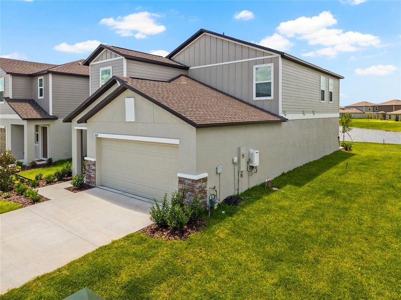 Front exterior of a new home in Prosperity Lakes, Parrish, FL, highlighting curb appeal (Image 2). Front exterior of a new home in Prosperity Lakes, Parrish, FL, highlighting curb appeal (Image 2).