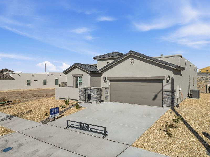 Front exterior of a new home in Emerald Estates, El Paso, TX, highlighting curb appeal (Image 2).