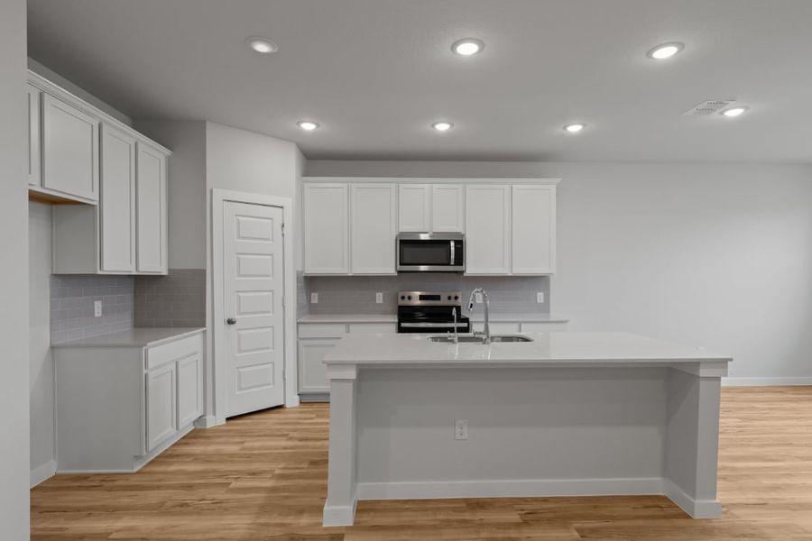 A kitchen with white cabinets. A kitchen with white cabinets.