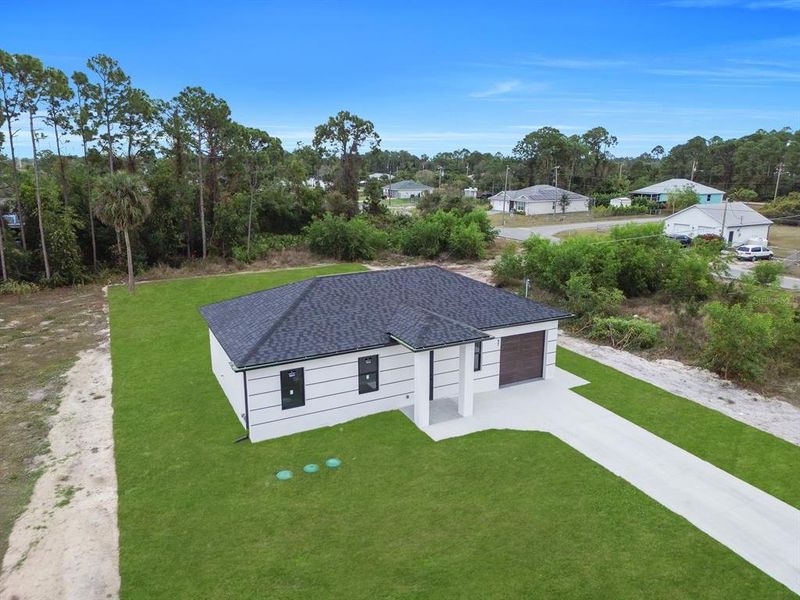 Front exterior of a new home in , Lehigh Acres, FL, highlighting curb appeal (Image 21).