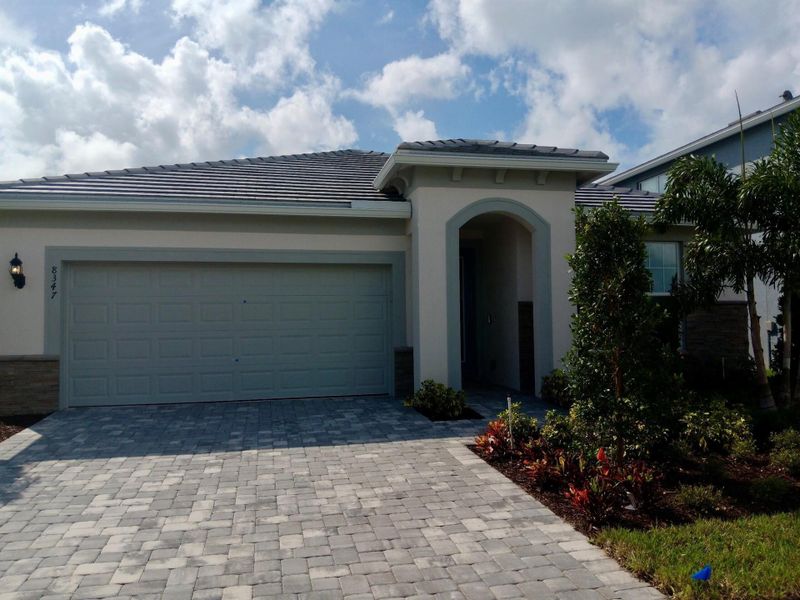 Front exterior of a new home in Harbor Isle, Vero Beach, FL, highlighting curb appeal (Image 1). Front exterior of a new home in Harbor Isle, Vero Beach, FL, highlighting curb appeal (Image 1).