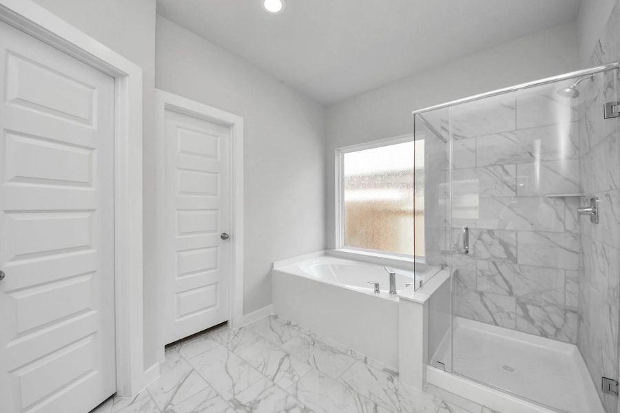 Indulge in a spa-like retreat within the confines of this primary bathroom. Indulge in a spa-like retreat within the confines of this primary bathroom.