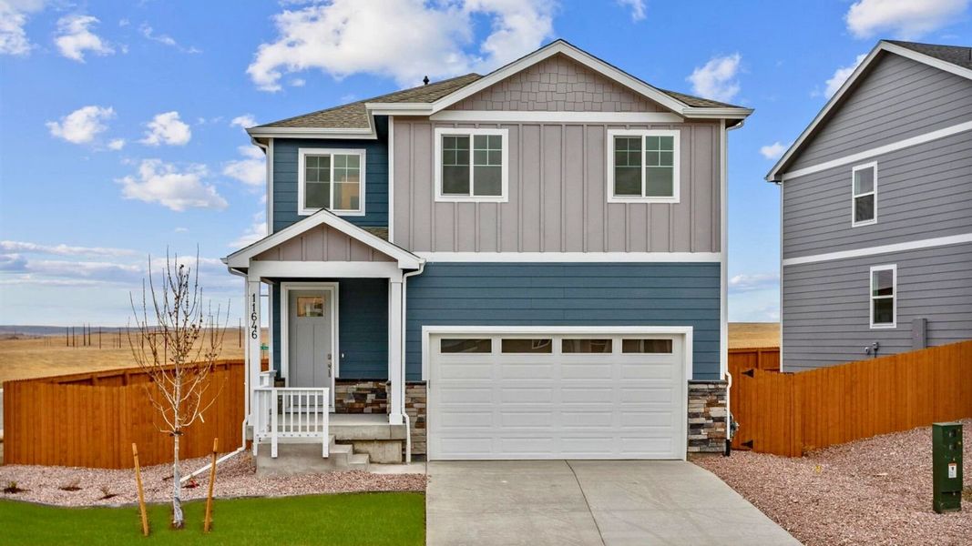 Front exterior of a new home in The Ridge at Lorson Ranch, Colorado Springs, CO, highlighting curb appeal (Image 1).