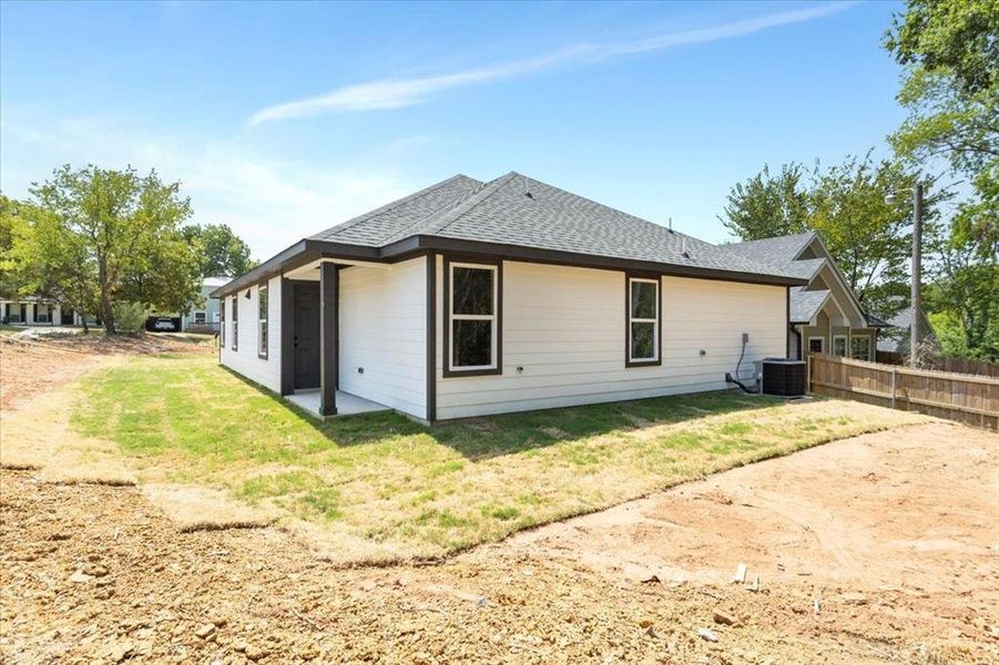 Rear view of property featuring central AC unit