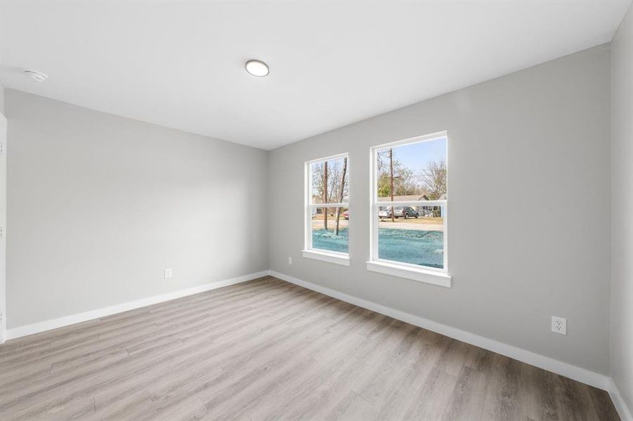 Empty room featuring baseboards and light wood-style floors Empty room featuring baseboards and light wood-style floors
