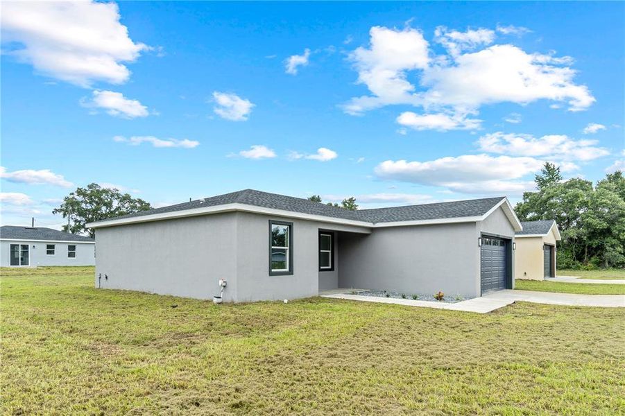 Front exterior of a new home in , Summerfield, FL, highlighting curb appeal (Image 1).