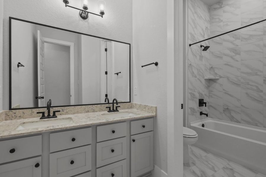 A bathroom with a tub sink and toilet. A bathroom with a tub sink and toilet.