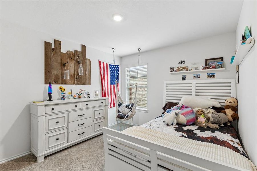 Bedroom featuring light colored carpet and baseboards Bedroom featuring light colored carpet and baseboards