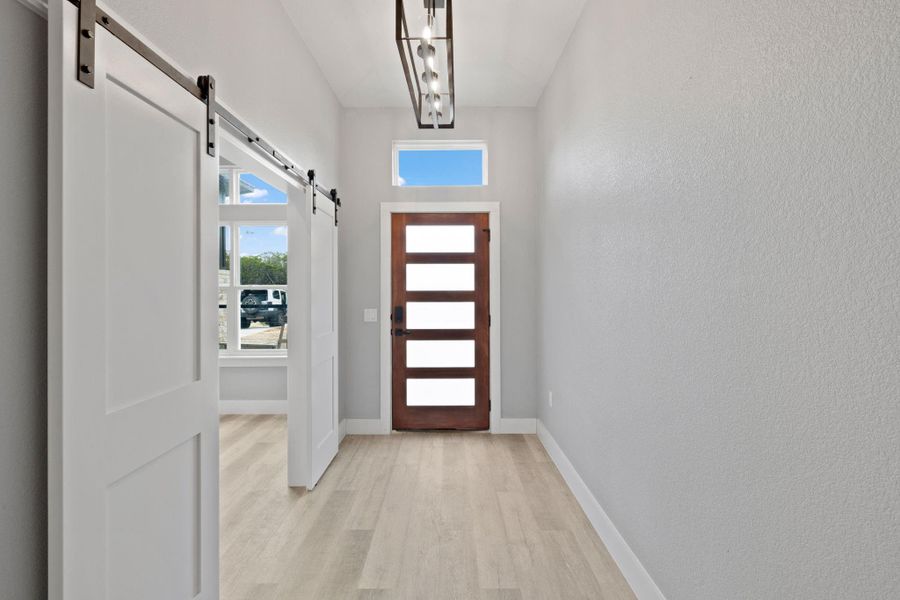 Entry way and office complete with barn style doors.