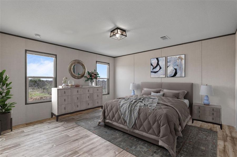 Bedroom featuring a decorative wall, light wood finished floors, and ornamental molding