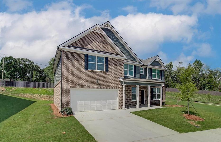 Front exterior of a new home in Kingsmere Estates, Loganville, GA, highlighting curb appeal (Image 1).