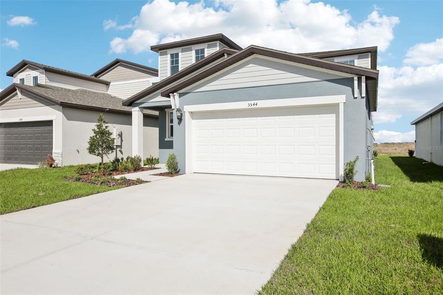 Front exterior of a new home in Benton Hills - Premier Series, Brooksville, FL, highlighting curb appeal (Image 19). Front exterior of a new home in Benton Hills - Premier Series, Brooksville, FL, highlighting curb appeal (Image 19).