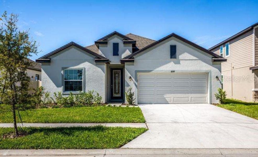 Front exterior of a new home in Royal Highlands, Brooksville, FL, highlighting curb appeal (Image 1). Front exterior of a new home in Royal Highlands, Brooksville, FL, highlighting curb appeal (Image 1).