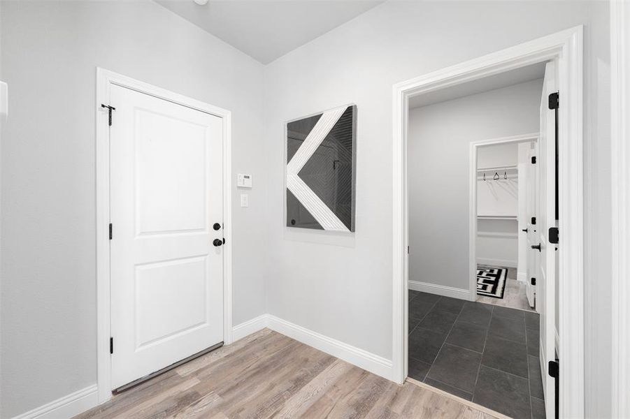 Foyer entrance with hardwood / wood-style flooring