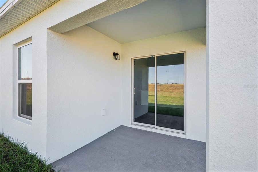 Exterior details and patio area of a home in The Enclave at Scenic Terrace, Haines City (Image 3).