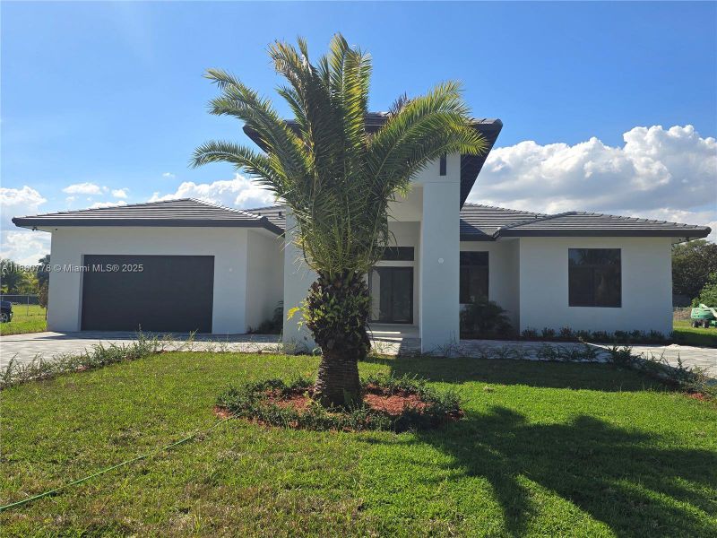 Front exterior of a new home in , Homestead, FL, highlighting curb appeal (Image 26).