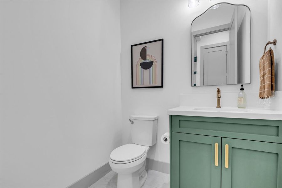 First-floor half bath features modern finishes and a clean, updated design, providing a stylish and convenient space for guests.