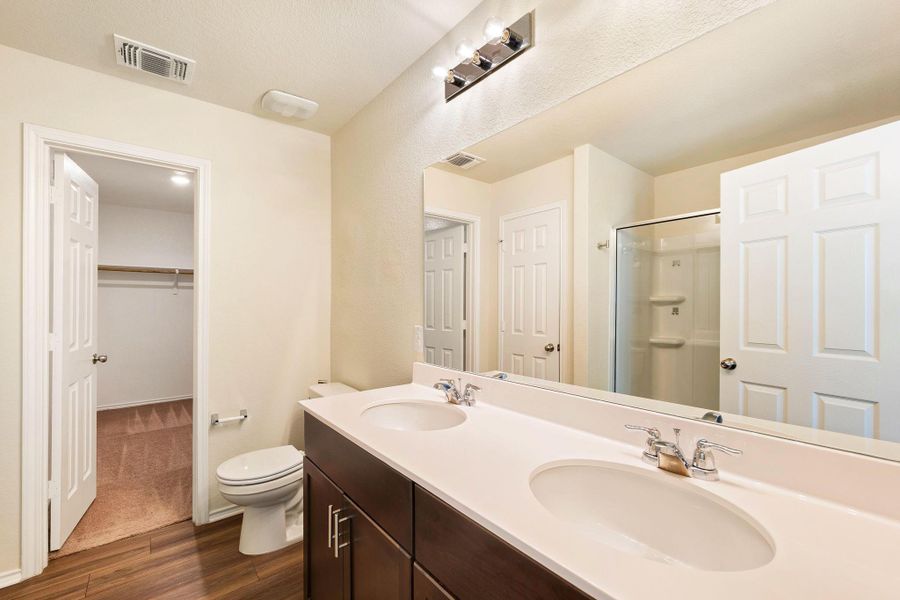 Double vanities and modern fixtures define this well-appointed bath. Double vanities and modern fixtures define this well-appointed bath.