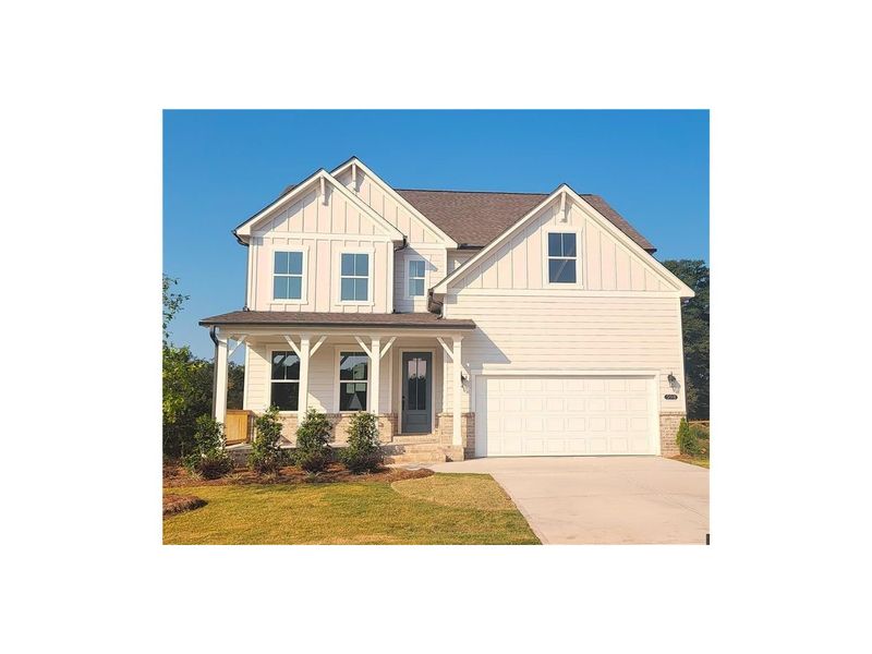 Front exterior of a new home in Wehunt Meadows, Hoschton, GA, highlighting curb appeal (Image 1).