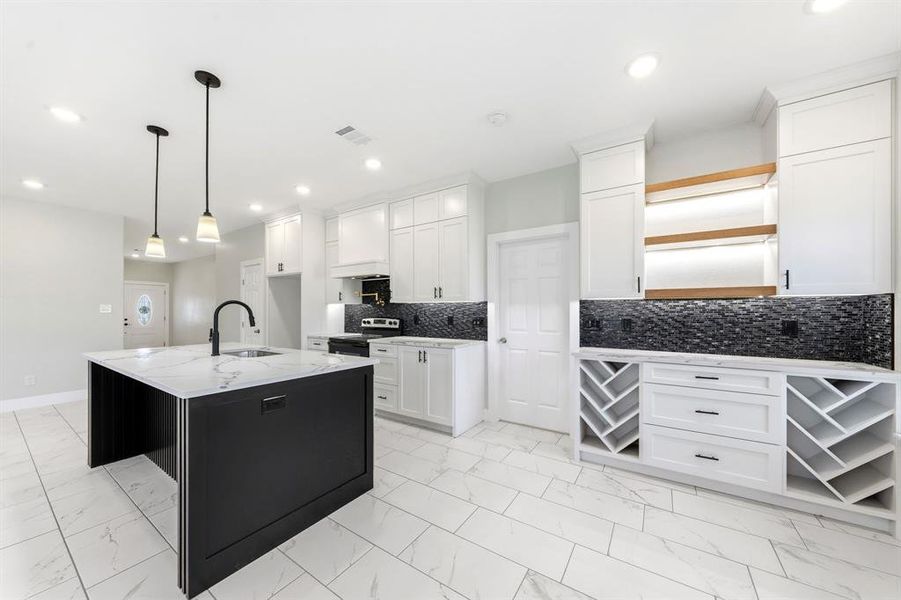 Kitchen with light marble finish flooring, decorative light fixtures, decorative backsplash, and light stone countertops