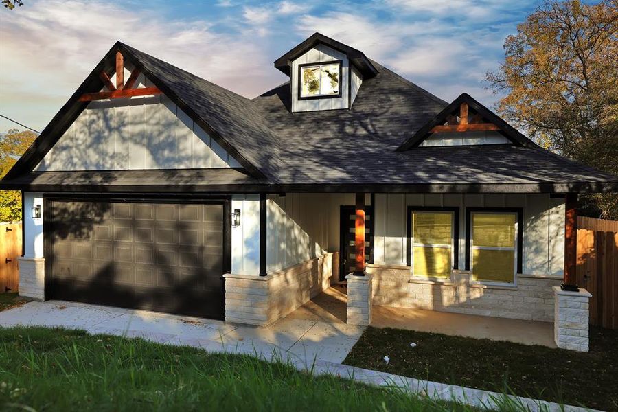 View of front of home featuring a porch and a garage