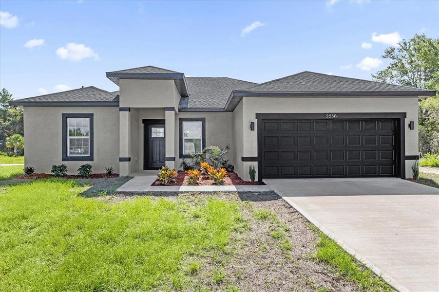 Front exterior of a new home in , Ocala, FL, highlighting curb appeal (Image 1).