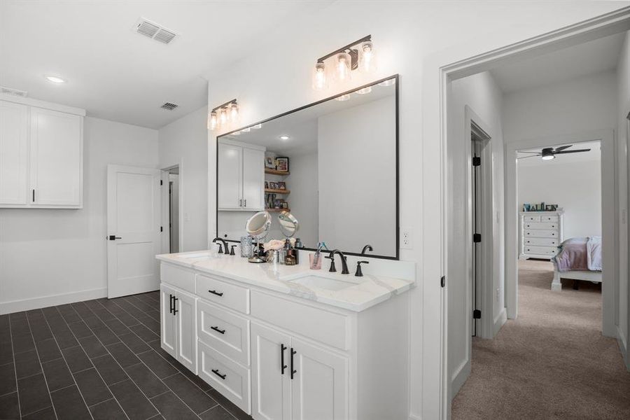 Ensuite bathroom with double vanity, a ceiling fan, baseboards, recessed lighting, and tile patterned flooring Ensuite bathroom with double vanity, a ceiling fan, baseboards, recessed lighting, and tile patterned flooring