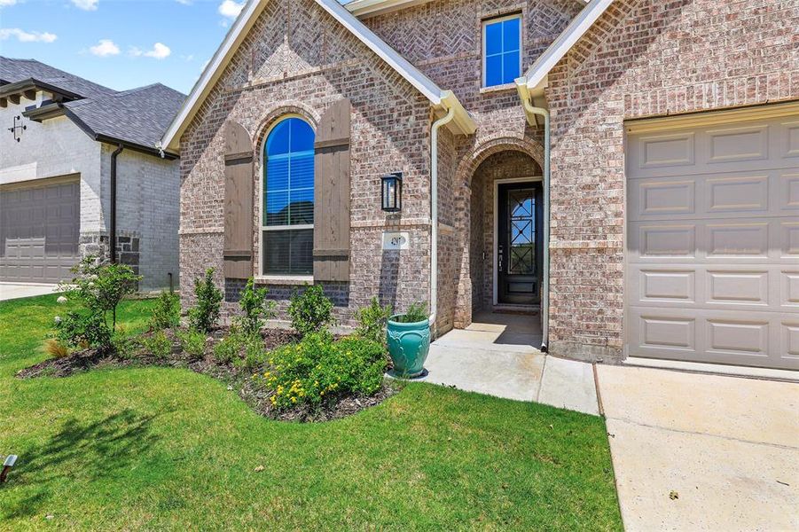 Gorgeous curb appeal with the stained cedar shutters and custom iron front door Gorgeous curb appeal with the stained cedar shutters and custom iron front door