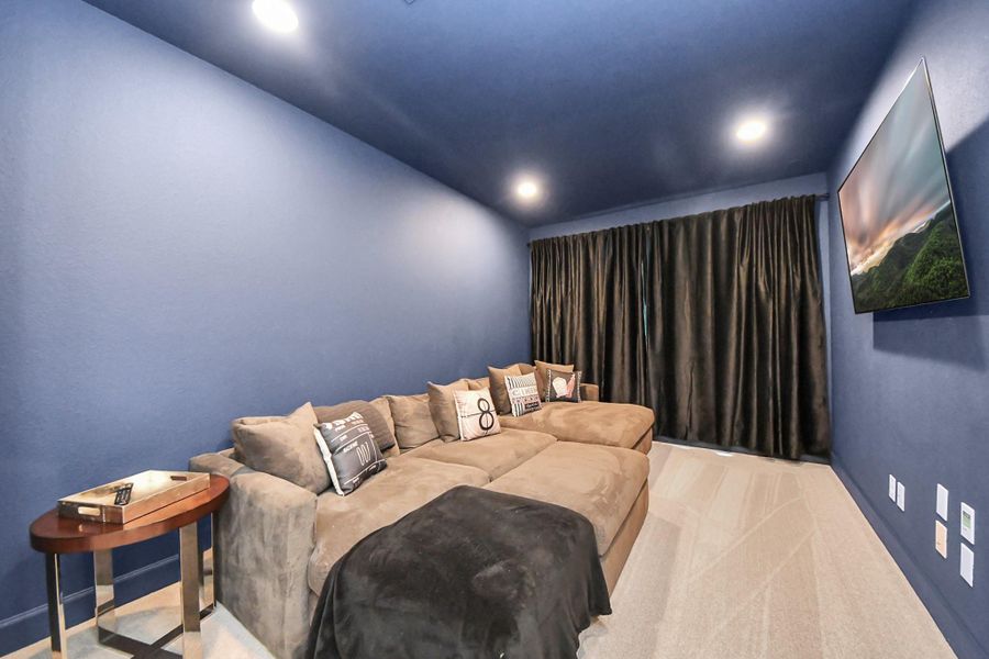 Dedicated entertainment space with tiered seating layout and recessed lighting.