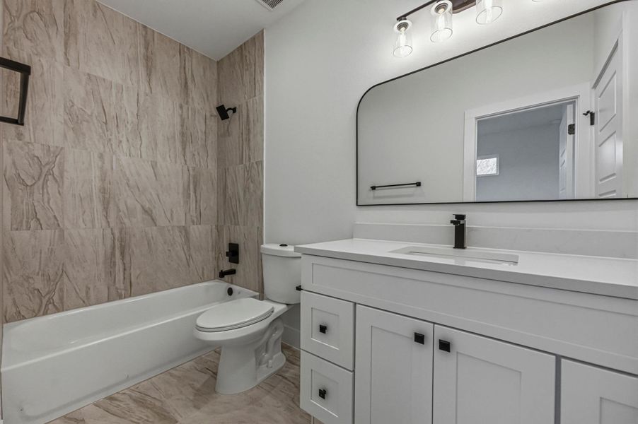 Bathroom with vanity and bathing tub / shower combination