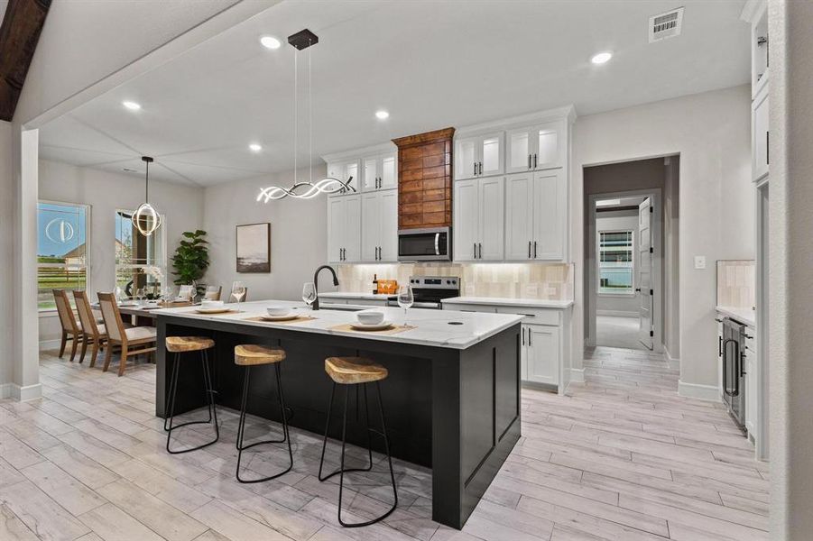 Kitchen featuring pendant lighting, glass insert cabinets, decorative backsplash, plenty of natural light, and recessed lighting