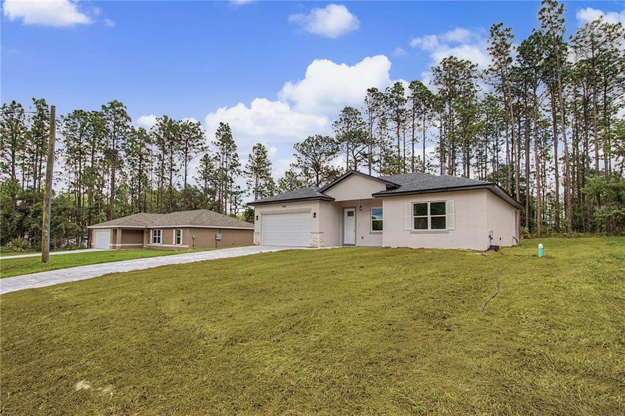 Front exterior of a new home in , Citrus Springs, FL, highlighting curb appeal (Image 24). Front exterior of a new home in , Citrus Springs, FL, highlighting curb appeal (Image 24).