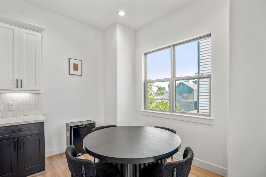 Natural light floods this intimate dining nook, making every meal feel like a special occasion.