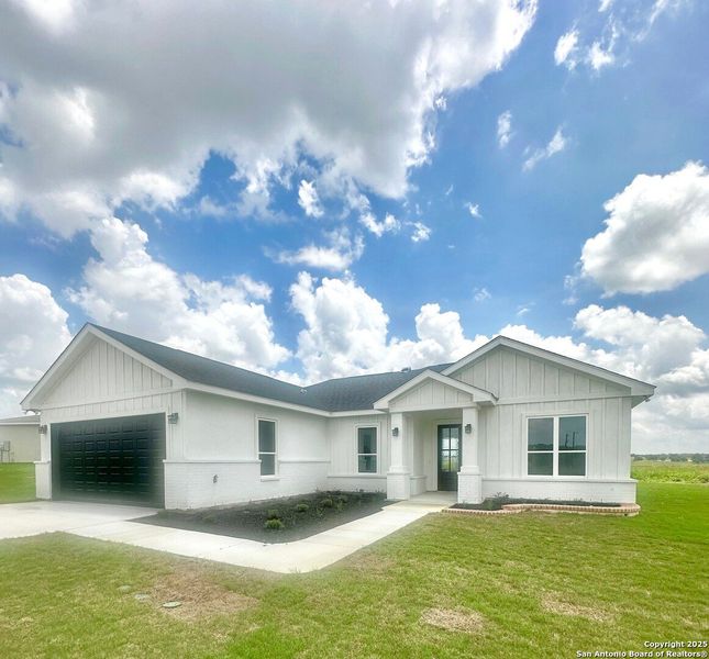 Front exterior of a new home in , La Vernia, TX, highlighting curb appeal (Image 24). Front exterior of a new home in , La Vernia, TX, highlighting curb appeal (Image 24).