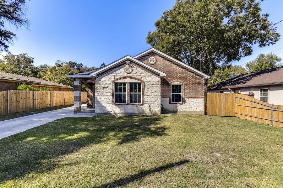 Rear view of house featuring a yard