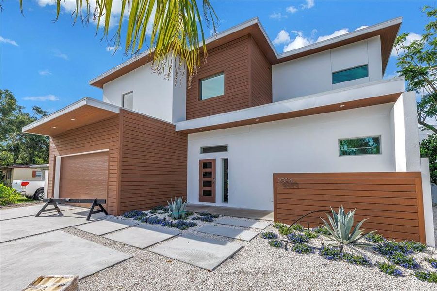 Front exterior of a new home in , Sarasota, FL, highlighting curb appeal (Image 24).